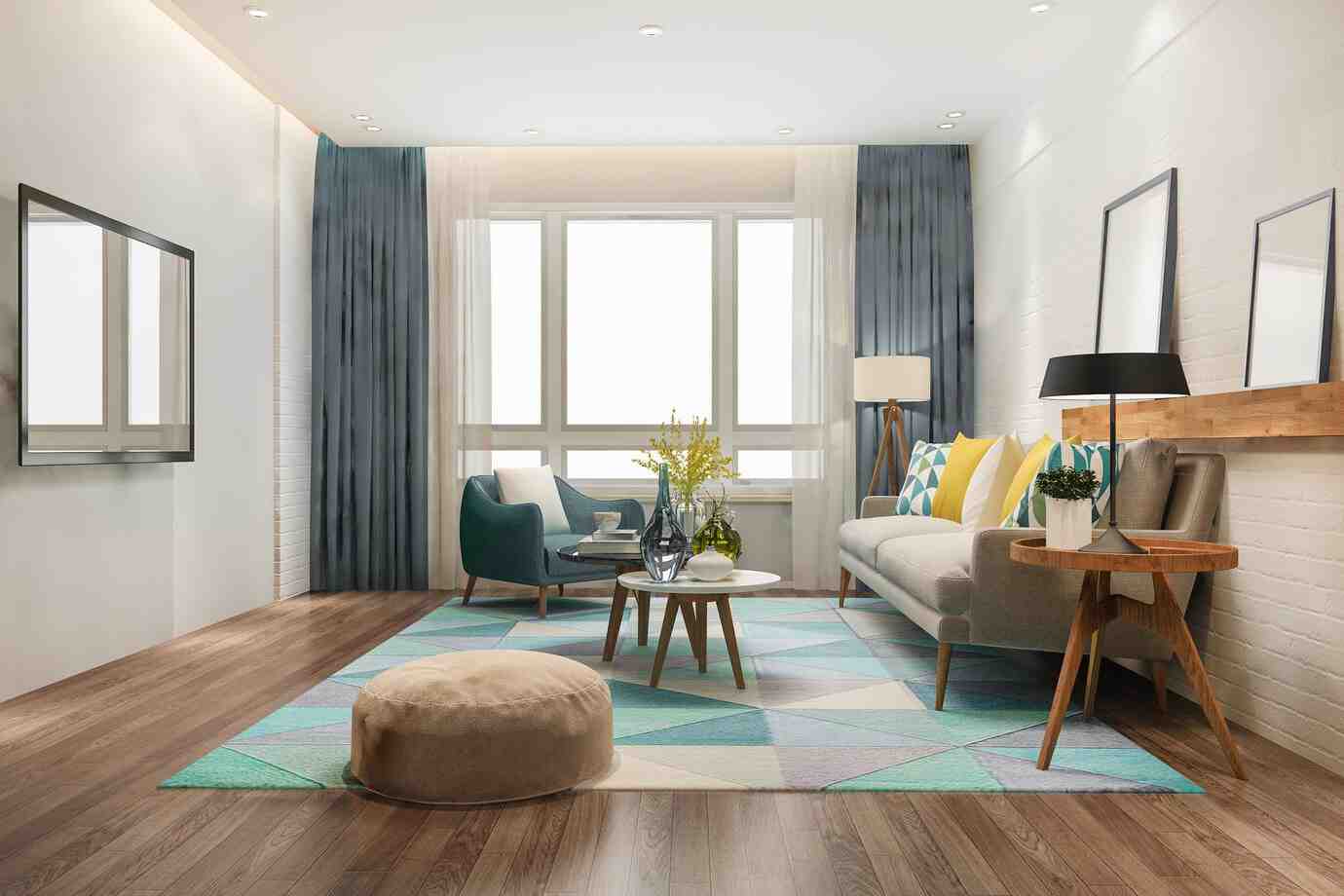 A modern living room featuring a sofa with colorful pillows, elegant blue curtains, a round coffee table, and a cozy pouf on a geometric rug.